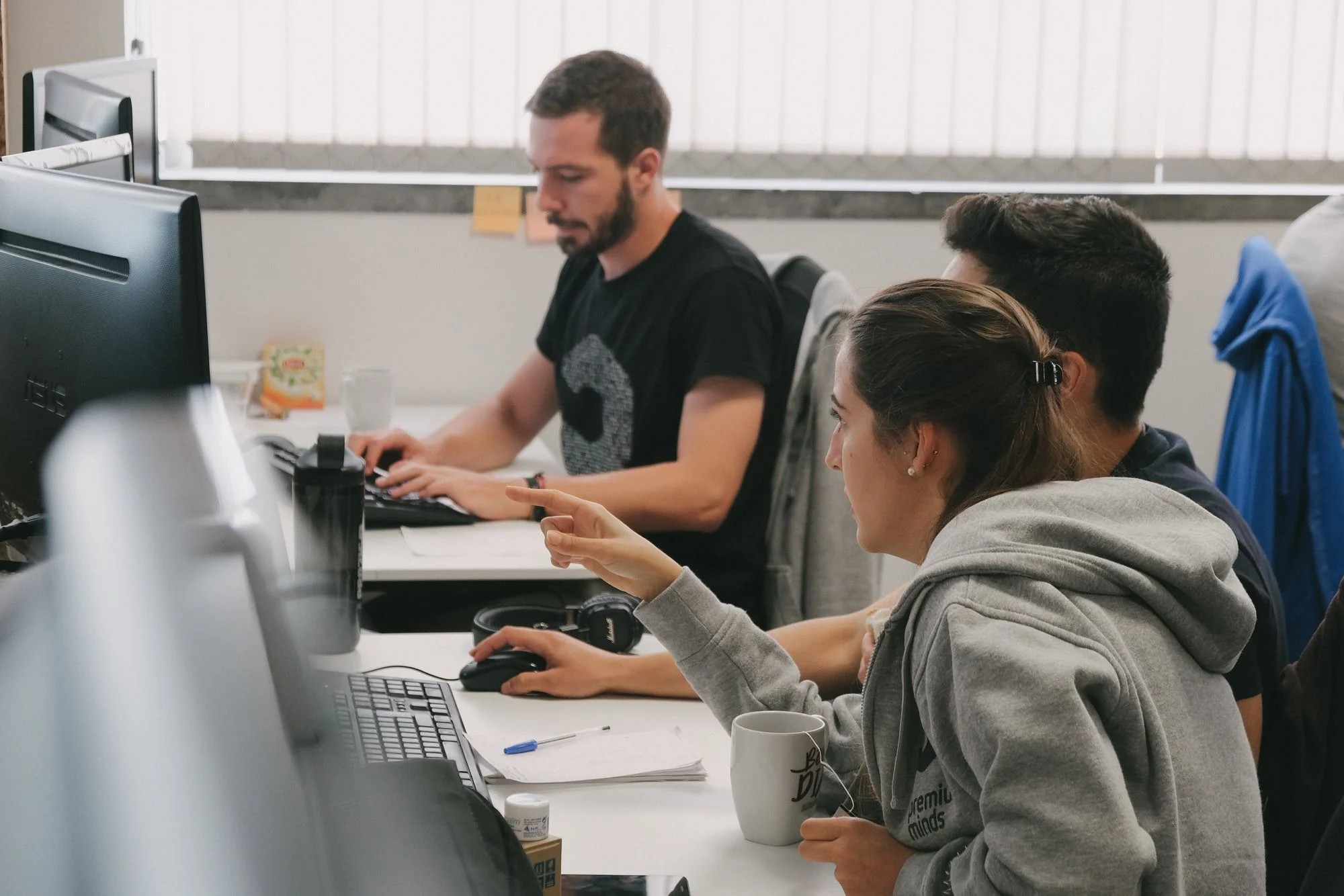 Group of young people working together and focusing on solving programming problems at Premium Minds' office