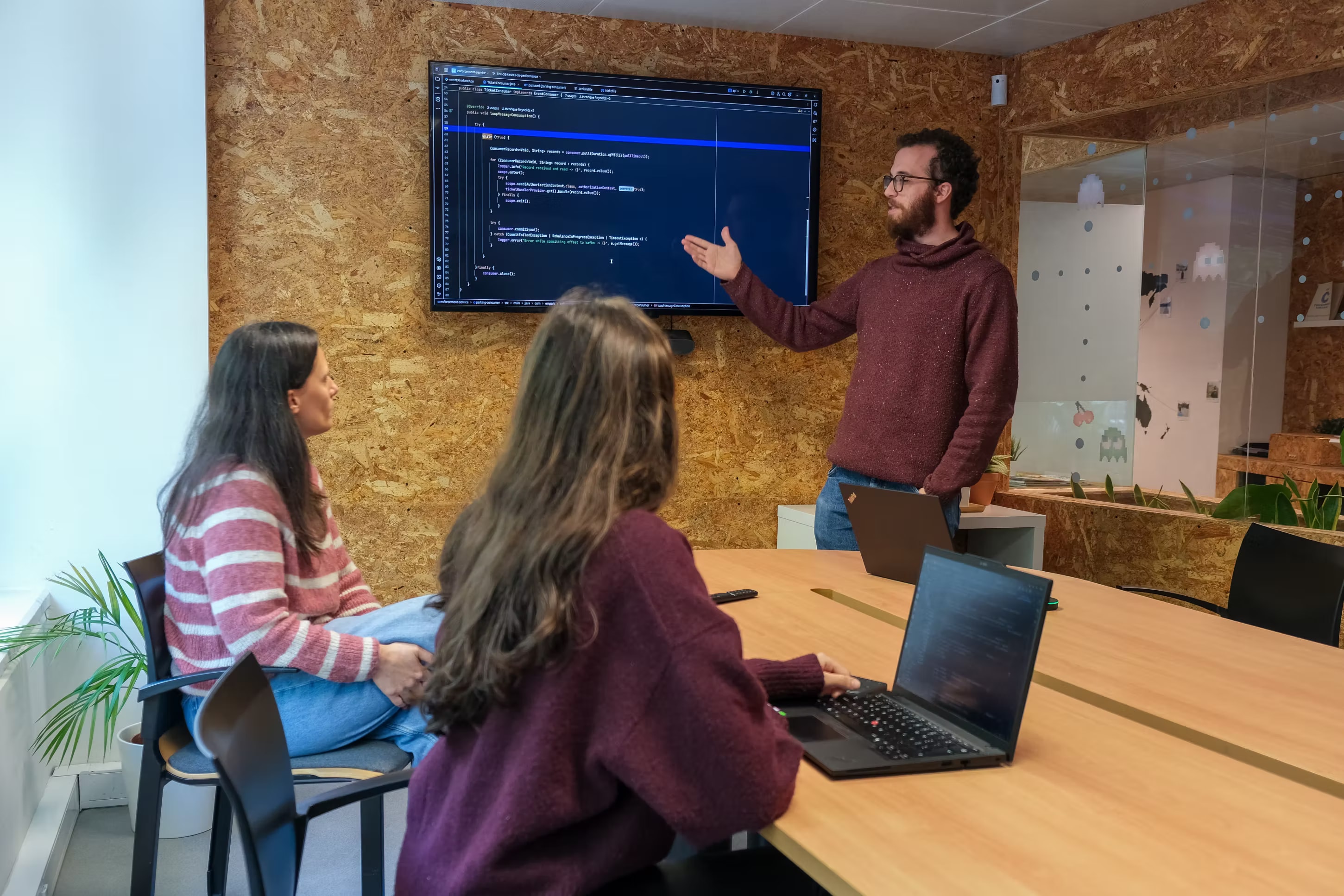 Group of young people working together and focusing on solving programming problems at Premium Minds' office