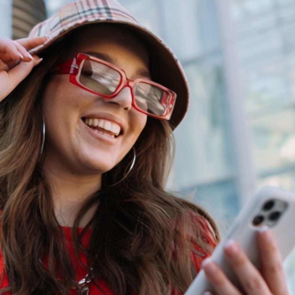 A young woman smiling while using the web app.